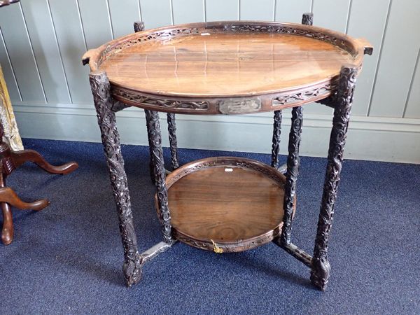 A CHINESE OCCASIONAL TABLE, THE TWO CIRCULAR TRAYS ON HEAVILY CARVED FOLDING STAND