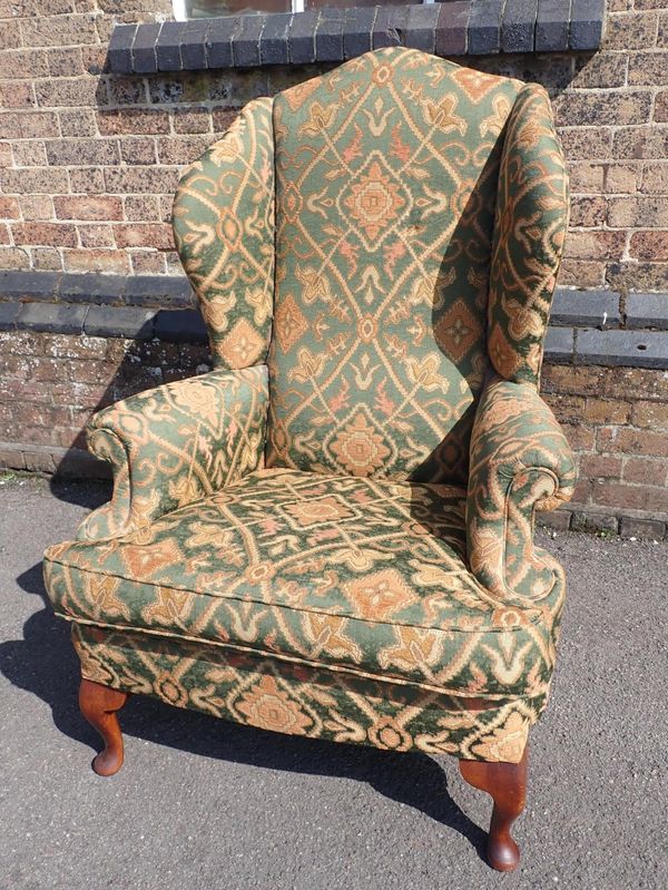 A GEORGE III STYLE WING ARMCHAIR