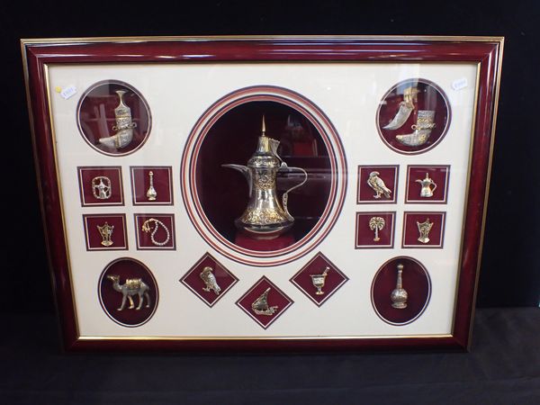 A FRAMED DISPLAY OF MIDDLE EASTERN WHITE METAL OBJECTS