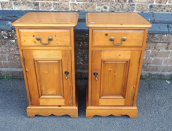 A PAIR OF PINE BEDSIDE CUPBOARDS