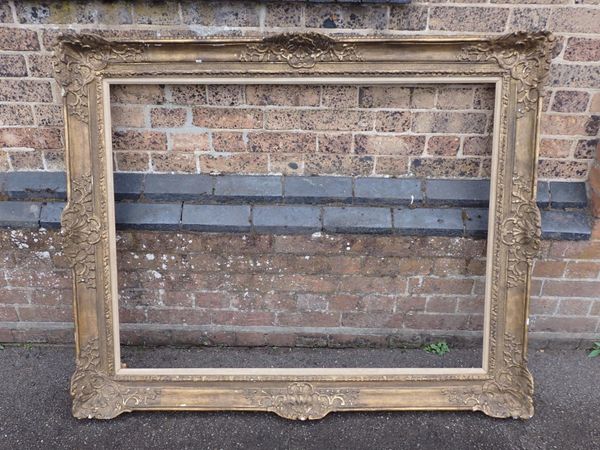 A LARGE MOULDED AND GILT GESSO PICTURE FRAME