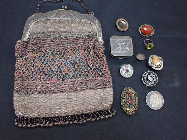 A BEADWORK PURSE WITH EMBOSSED METAL FRAME