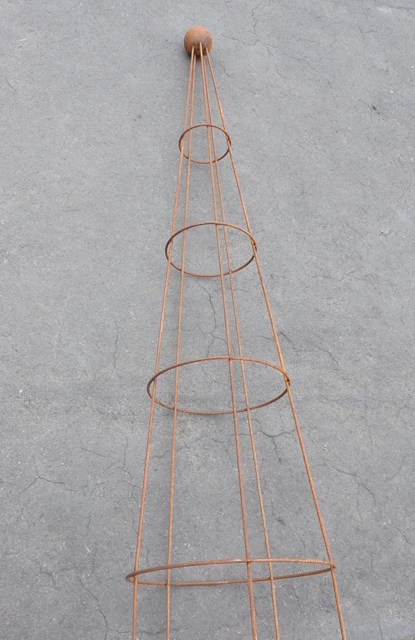 A METAL GARDEN OBELISK