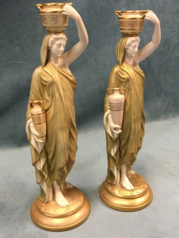 A pair of Royal Worcester water carrier figurines