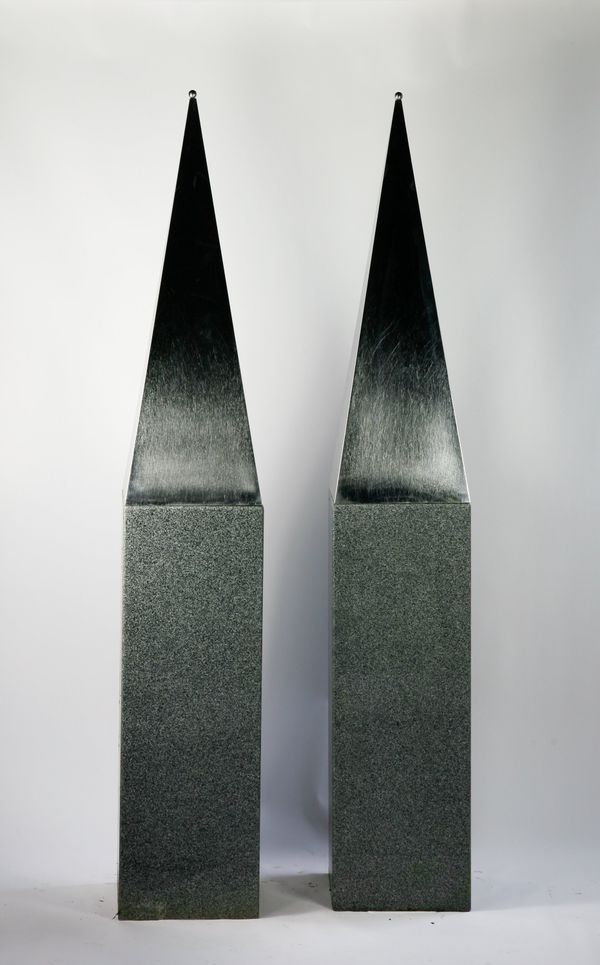 †A pair of stainless steel obelisks on granite bases (daggered lot)