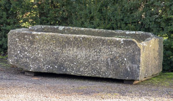 A carved sandstone trough 39cm high by 138cm long by 71cm deep 