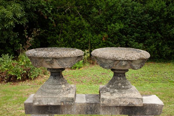 A pair of large carved York stone urns
