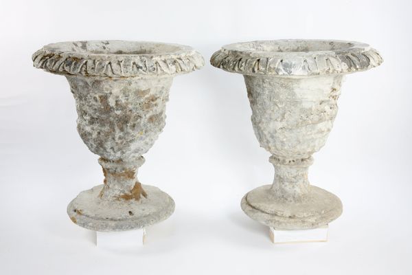 A pair of carved stone urns