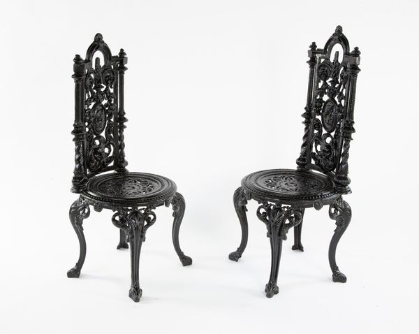 A pair of cast iron 'Napoleon' chairs