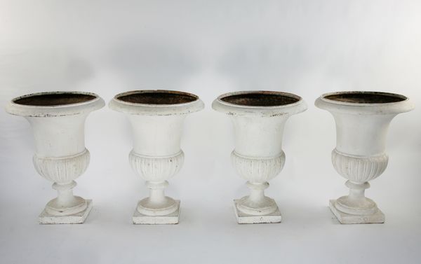 A set of four cast iron urns