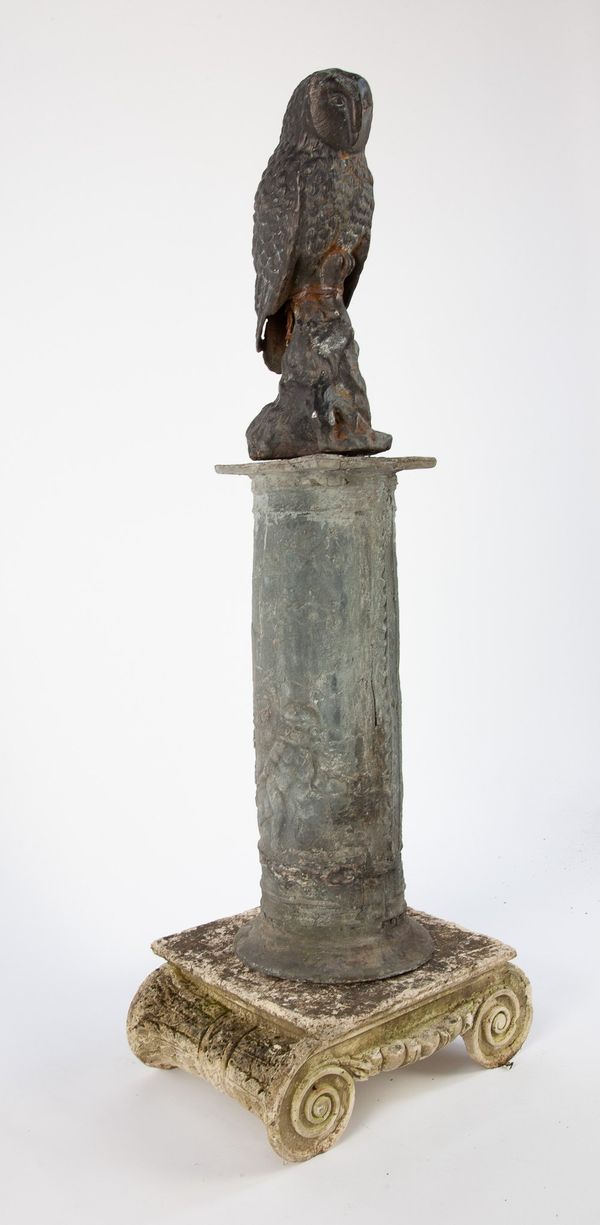 A cast iron owl on lead plinth