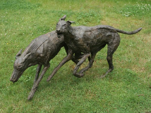 Marjan Wouda, Born 1960 Running Dogs Bronze mid-brown patination Signed and numbered 5 of 6 80cm high by 70cm deep by 170cm long