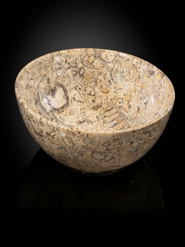 A collection of 22 marble and onyx eggs in fossil marble bowl the bowl 30cm diameter