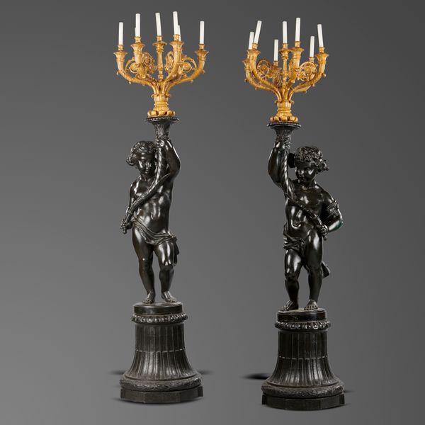A pair of cast iron putti candelabra figures  French, last quarter 19th century on pedestals with seven branch ormolu candelabrae 216cm high  
