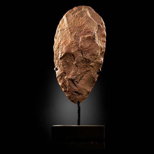A large stone Adze Sahara, Acheulian on bronze stand 29cm high overall