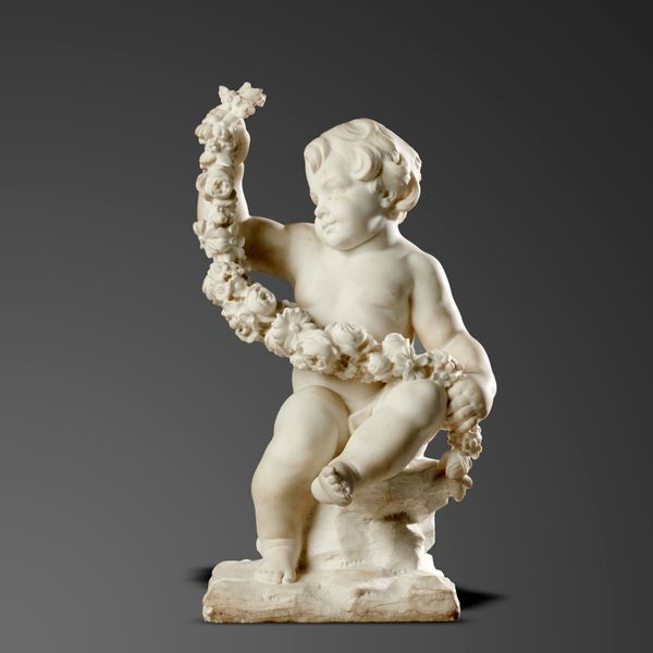 A pair of white marble putti holding garlands of flowers Northern European, 19th century 64cm high by 33cm wide by 34cm deep