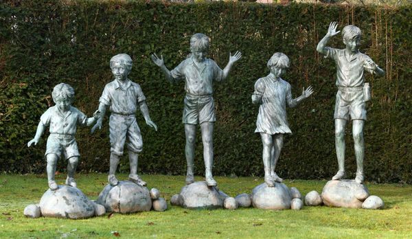 After Eneri Prosperi: A bronze group of five children each standing on stepping stones one with original sculptor‘s plaque stamped Bronze Elite by...