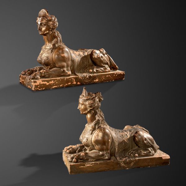 A pair of Coade style terracotta sphinxes late 19th/early 20th century  one bearing the stamp Coade, Lambeth 80cm high by 102cm long  This sphinx...