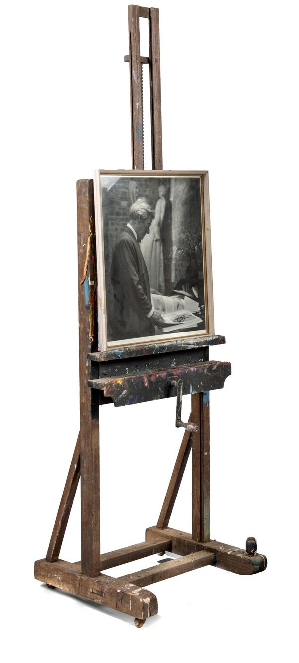 A painted wood and iron mounted easel 1st half 20th century 220cm high, together with a black and white photograph of Sir Charles Wheeler This and...