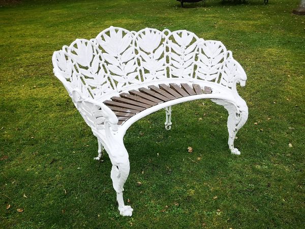 A Coalbrookdale Laurel pattern cast iron seat circa 1870 foundry marks possibly obscured by old paint 120cm wide This design number 129358 was...