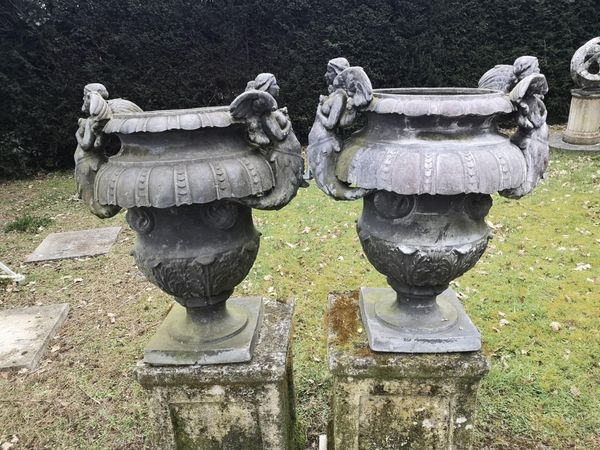 A pair of Wimperis and Best lead urns early 20th century 69cm high  This model is attributed to the firm of Wimperis and Best by Lawrence Weaver in...