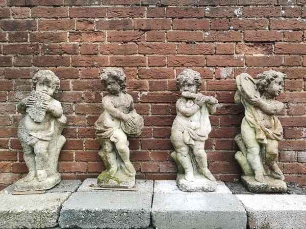 A set of four composition stone putti musicians 2nd half 20th century 70cm high  From a Private Collection in Ireland, see lot 35 for further...