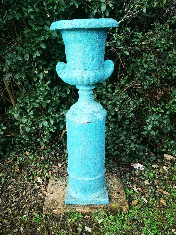 Gerald Moore  A composition urn with sprayed blue finish on column pedestal 127cm high Part of the Late Dr Gerald Moore Collection of Paintings and...