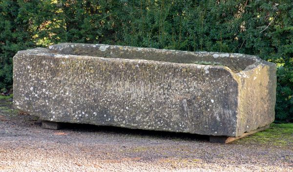A carved sandstone trough 39cm high by 138cm long by 71cm deep