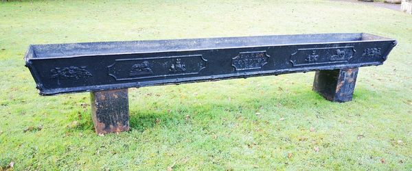 A rare early Victorian cast iron trough stamped Baker, Compton and dated 1842 on later supports the trough 30cm high; 72cm high overall by 343cm long...