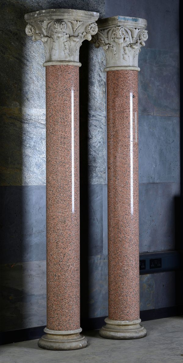 A pair of large pink granite columns 2nd half 19th century white marble Corinthian capitals and bases 259.5cm high, the capitals 53.5cm wide