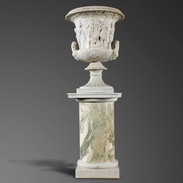 A carved white marble Medici urn late 19th century 93cm high on associated marble pedestal, 186cm high overall Provenance: Major Ion R. Harrison...