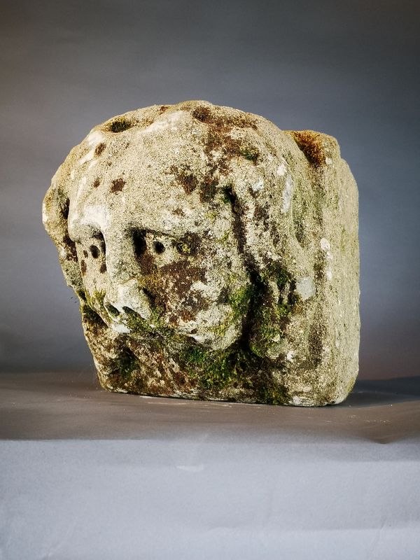 A similar carved limestone architectural head probably late medieval, English or French 15th century 26cm high by 26cm wide by 29cm deep