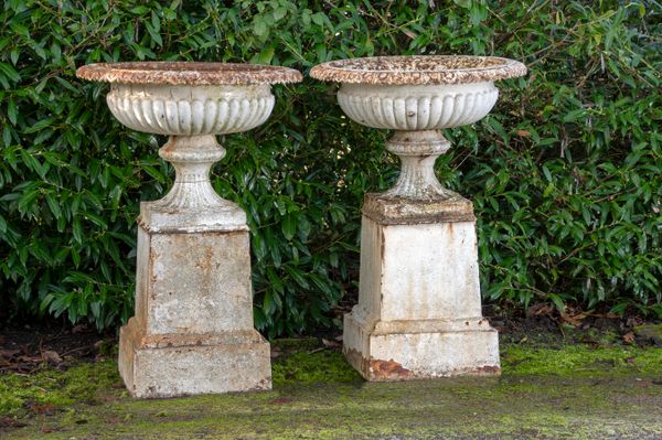 A pair of cast iron urns on pedestals 2nd half 19th century 110cm high by 75cm diameter