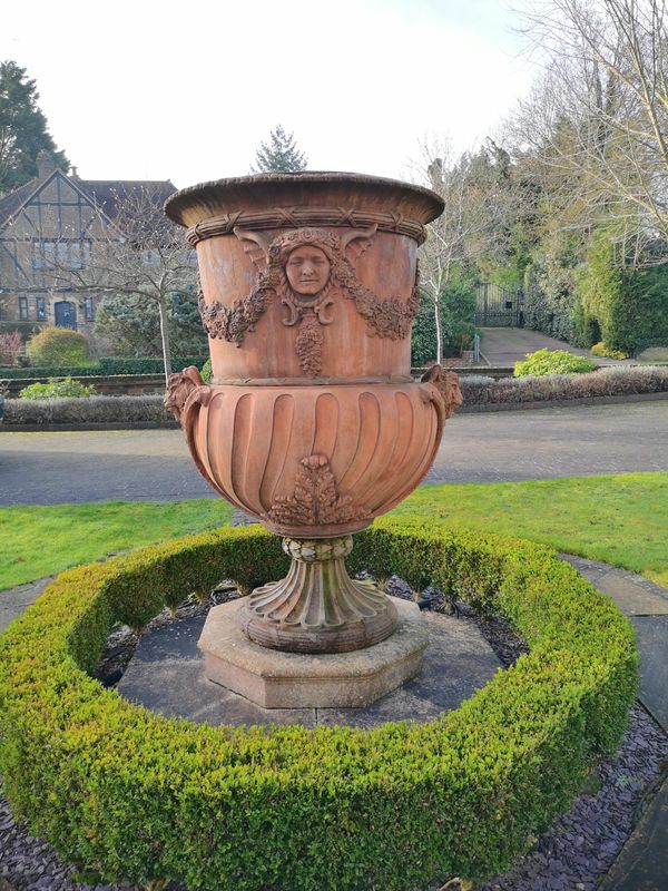 A substantial composition stone urn on plinth  178cm high by 131cm wide Provenance: From a private garden in Totteridge, North London