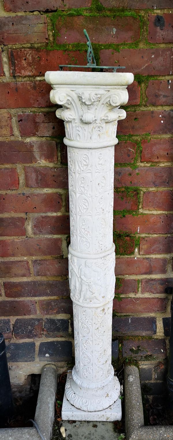 A Romanesque style composition stone sundial with bronze plate 115cm high overall Provenance: From a private garden in Totteridge, North London