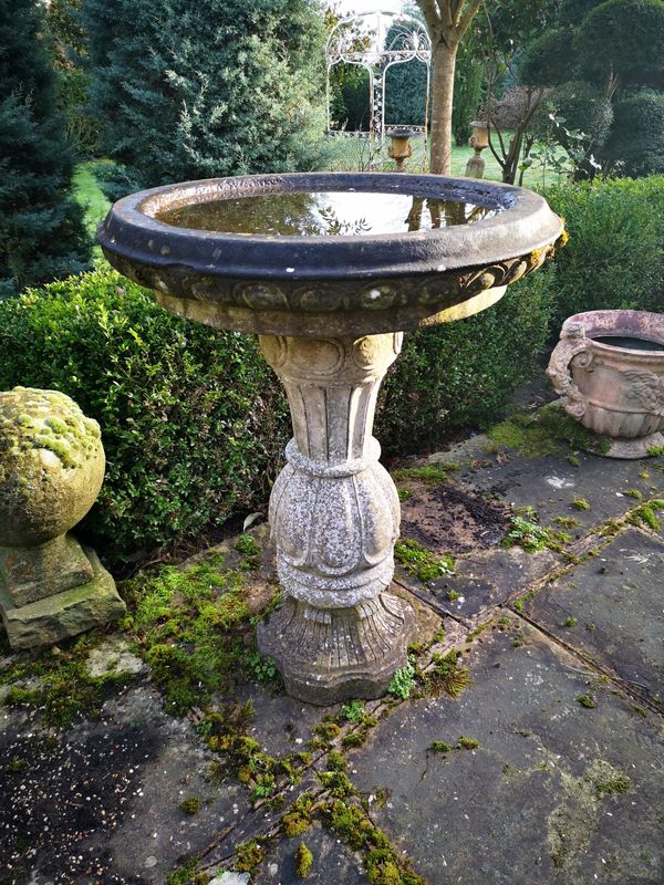 A composition stone bird bath  2nd half 20th century 94cm high by 72cm diameter Provenance: From a private garden in Totteridge, North London