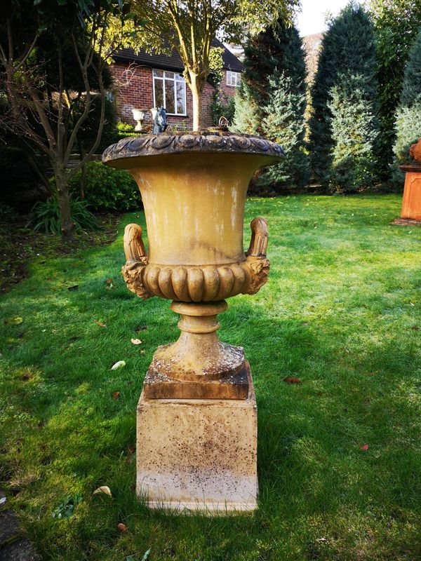 A pair of Doulton style composition stone urns on pedestals 2nd half 20th century 108cm high Provenance: From a private garden in Totteridge, North...