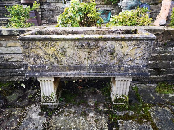 A pair of composition stone rectangular troughs on stands 80cm high by 118cm long Provenance: From a private garden in Totteridge, North London