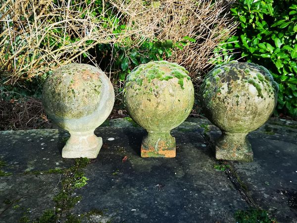 A set of three terracotta gate pier balls 20th century 45cm high Provenance: From a private garden in Totteridge, North London