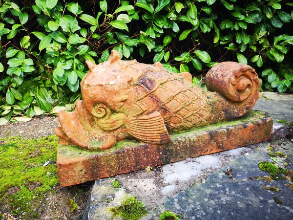 A pair of unusual terracotta stylised dolphin fountains by Alan Frost late 20th century mouths drilled for water, signed Alan Frost, Malmesbury 46cm...