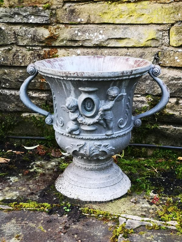 A pair of lead urns modern 45cm high, together with a William and Mary lead style fibreglass urn, modern, 39cm high Provenance: From a private...