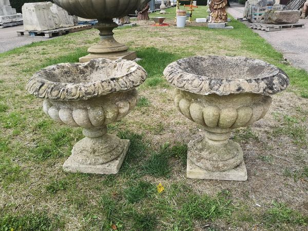 A pair of carved Cotswold stone urns 19th century 47cm high
