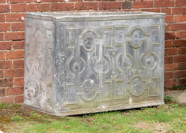 A Georgian lead cistern  the front and sides dated 1750 and the initials WWA with armorials including elephants heads 76cm high by 103cm long by 53cm...