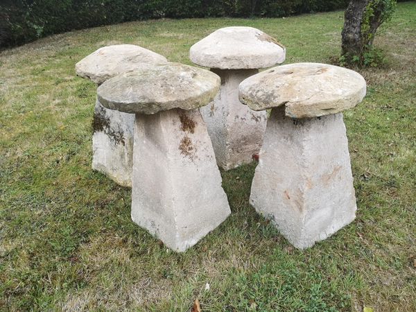 A harlequin set of four Cotswold stone staddlestones average height 74cm