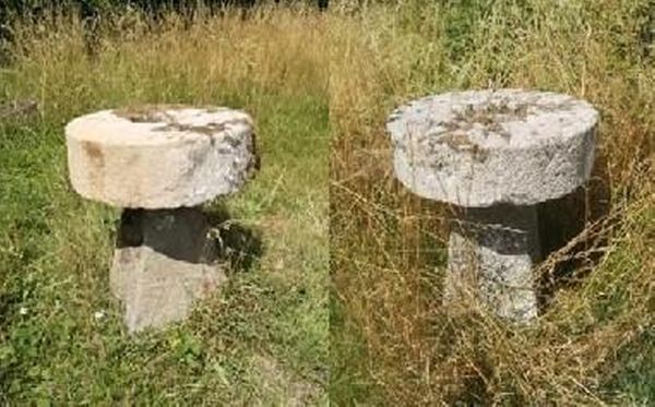 A pair of carved stone tables with millstone tops on staddlestone bases one base sandstone, the other slate 80cm high by 66cm diameter