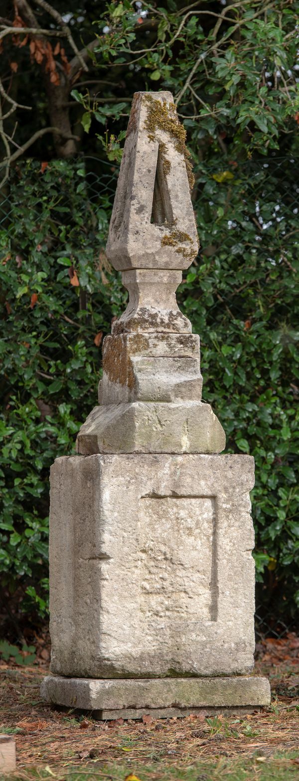 An unusual carved stone finial on associated base mid 19th century 220cm high