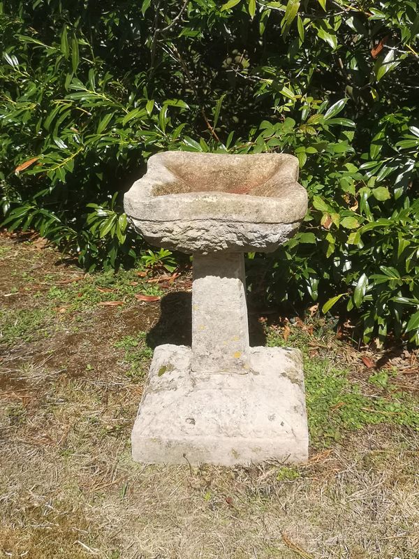 A carved Cotswold stone Arts and Crafts style birdbath early 20th century 54cm high