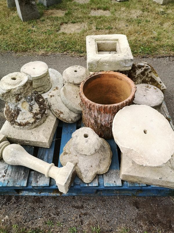 A collection of carved stone and serpentine marble urn and rockery fragments including three cast iron rainwater hoppers, one dated 1860