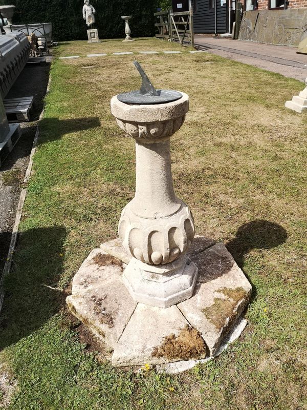 A carved Cotswold stone sundial pedestal on plinth base late 19th century with 22cm bronze dial signed Pattrick, London on plinth base 108cm high 