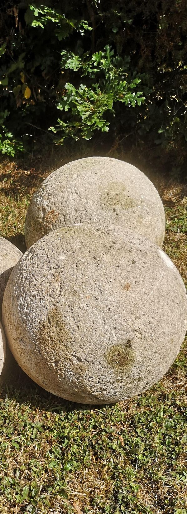 A pair of carved Cotswold stone gate pier balls 32cm diameter
